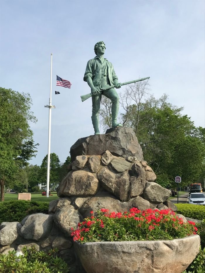 Iconic Minute Man Statue at Lexington Common in springtime.